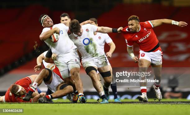 Mako Vunipola and Tom Curry of England drive forward as Willis Halaholo of Wales looks to challenge during the Guinness Six Nations match between...