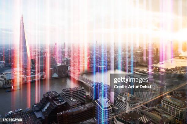 colorful lights emerging from the city of london with global connections. - global media stockfoto's en -beelden