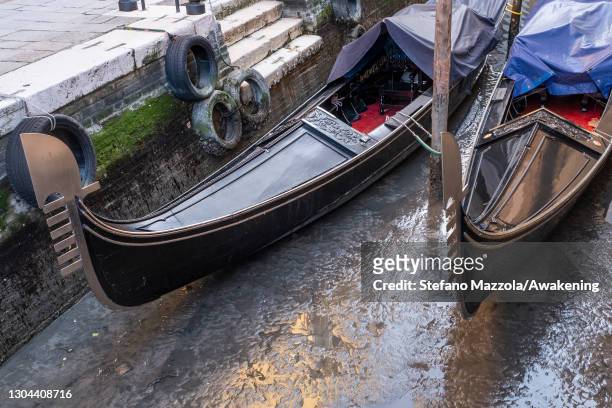 February 27: Gondolas are stucked in low tide in a little canal on February 27, 2021 in Venice, Italy. An exceptional low tide affected Venice this...