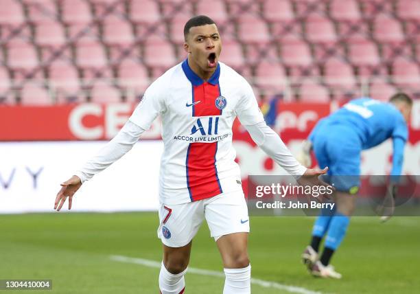 Kylian Mbappe of PSG celebrates his second goal while goalkeeper of Dijon Anthony Racioppi is dejected during the Ligue 1 match between Dijon FCO and...