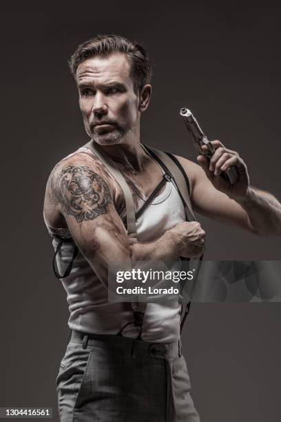 portrait of action hero looking man in studio shot - handsome tattoo stock pictures, royalty-free photos & images