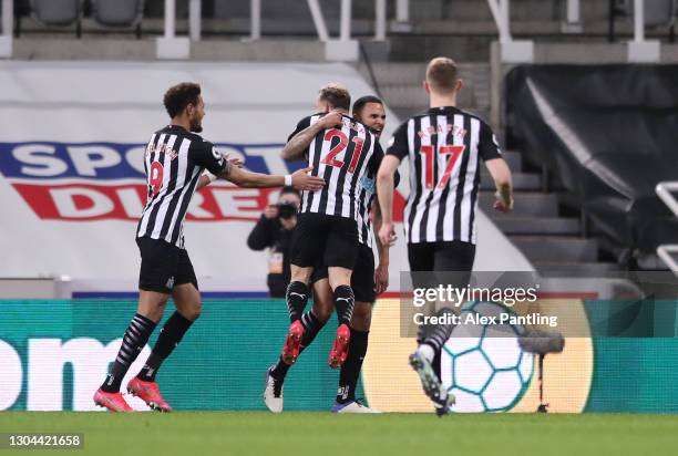 Jamaal Lascelles of Newcastle United celebrates with team mates Ryan Fraser and Joelinton after scoring their side's first goal during the Premier...