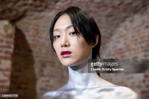 Model poses backstage prior to the Salvatore Ferragamo Fashion Show during the Milan Women's Fashion Week Fall/Winter 2021/2022 on February 27, 2021...