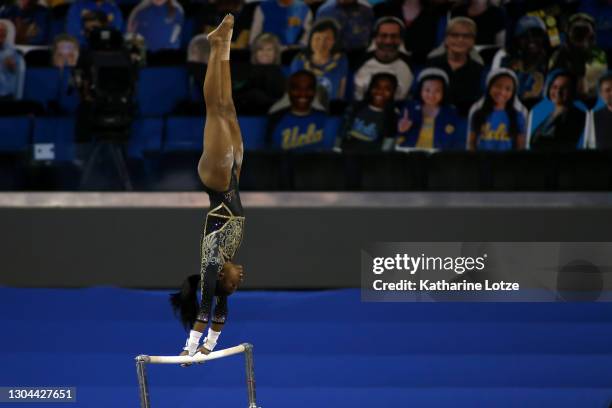 Nia Dennis of the UCLA Bruins competes on uneven bars during a meet against the Oregon State Beavers at Pauley Pavilion on February 27, 2021 in Los...