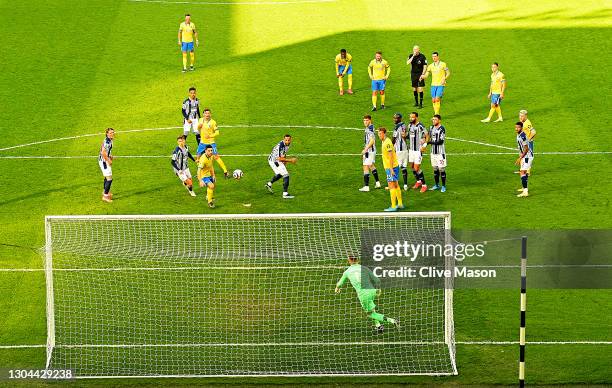 Lewis Dunk of Brighton & Hove Albion takes a free kick as referee Lee Mason blows the whistle. The free kick led to a goal, then following a VAR...