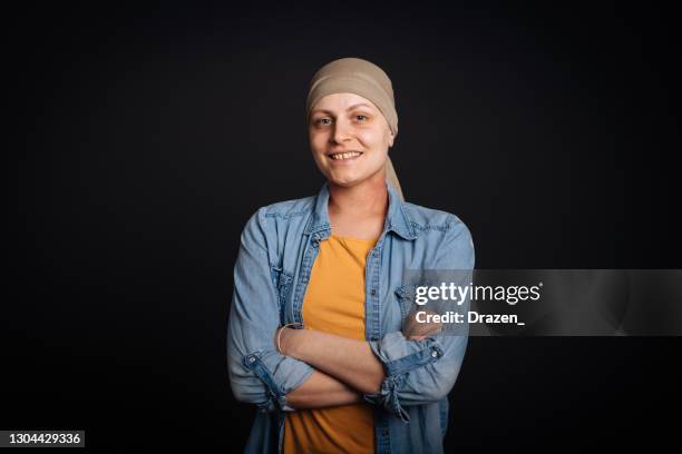 studio photo of smiling and optimistic female cancer patient, looking at camera - cancer portrait stock pictures, royalty-free photos & images