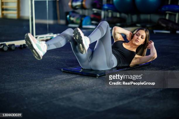 young attractive cool sporty woman doing crisscross fitness exercise, bicycle crunches, working out on the floor - core strength stock pictures, royalty-free photos & images