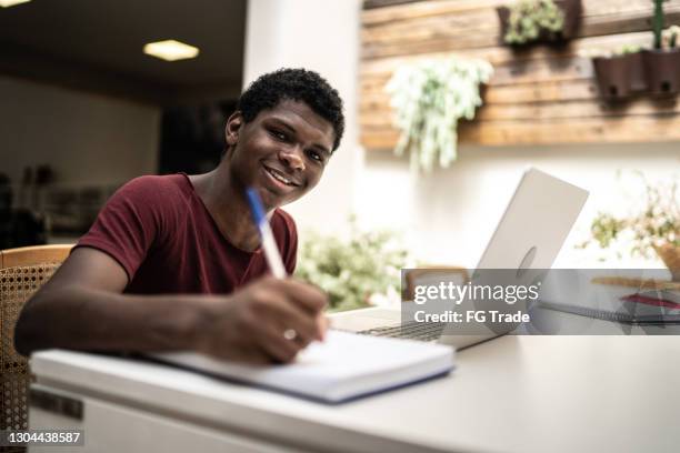 portrait of a teenager boy studying at home - 16 17 years stock pictures, royalty-free photos & images