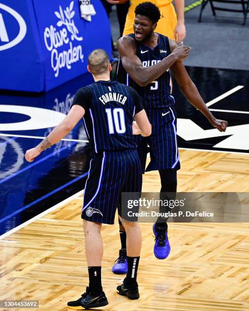 Mo Bamba of the Orlando Magic and Evan Fournier react during the second quarter against the Utah Jazz at Amway Center on February 27, 2021 in...