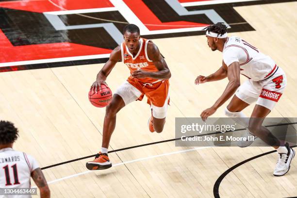 Guard Andrew Jones of the Texas Longhorns handles the ball during the first half of the college basketball game against the Texas Tech Red Raiders at...