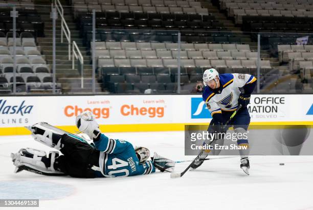Devan Dubnyk of the San Jose Sharks dives to make a save on Jordan Kyrou of the St. Louis Blues at SAP Center on February 27, 2021 in San Jose,...