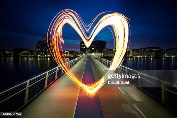 luminous love - glowing heart stock pictures, royalty-free photos & images