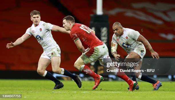 George North of Wales takes on Owen Farrell and Kyle Sinckler during the Guinness Six Nations match between Wales and England at Principality Stadium...