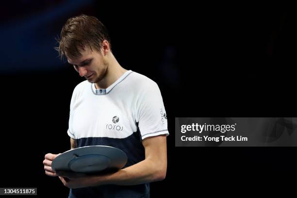 Alexander Bublik of Kazakhstan checks out the runner-up trophy after his Men's Singles Final match loss to Alexei Popyrin of Australia on day seven...