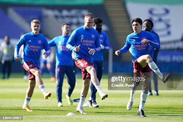 Rob Holding, Hector Bellerin and teammates warm up prior to the Premier League match between Leicester City and Arsenal at The King Power Stadium on...