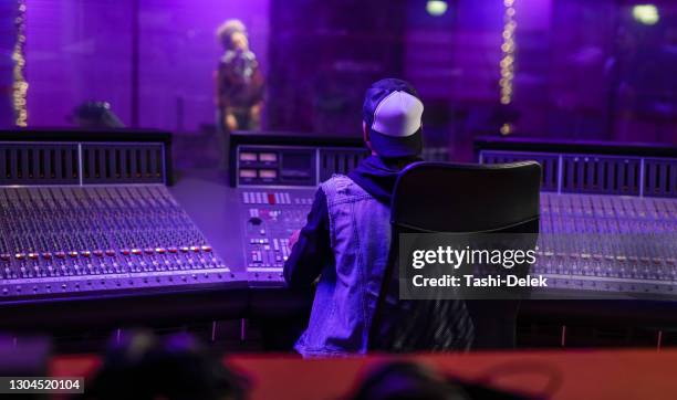 female vocalist and sound engineer working in studio - producer imagens e fotografias de stock