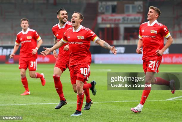 Max Kruse of 1.FC Union Berlin celebrates with teammates Christopher Trimmel and Grischa Proemel after scoring their team's first goal during the...