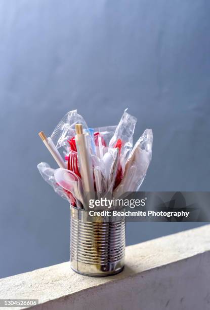 disposable spoons, forks ,chopsticks and tissue paper in a tin can on a ledge - disposable silverware stock pictures, royalty-free photos & images