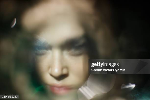 blurred sunny portrait of the young woman - bokeh woman stock pictures, royalty-free photos & images