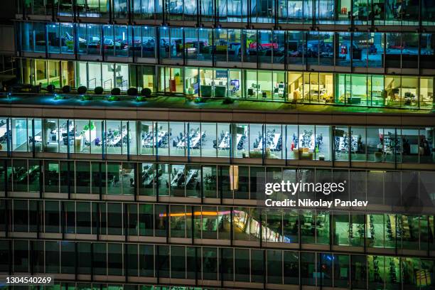 close up of illuminated modern offices during night hours in london city, uk - creative stock photo - abstract light busy stock pictures, royalty-free photos & images