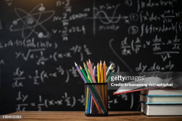 back to school supplies. books and blackboard on wooden background,education - brown v board of education stockfoto's en -beelden