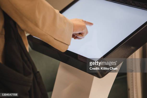 closeup of female hand using touch screen - interactive stock-fotos und bilder