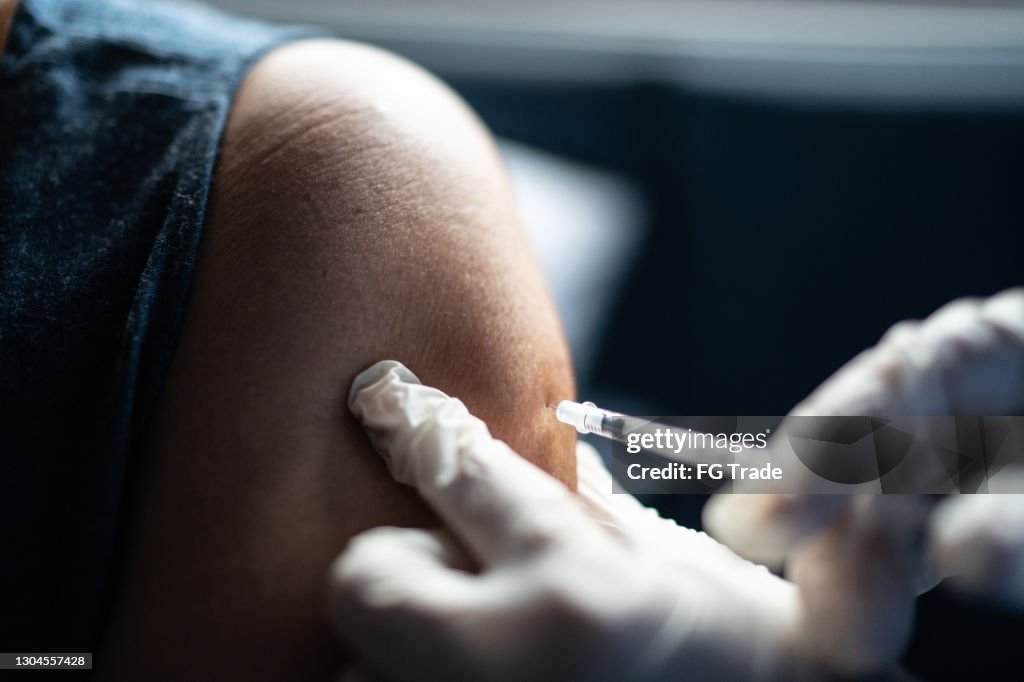 Vaccine being applied on human's arm