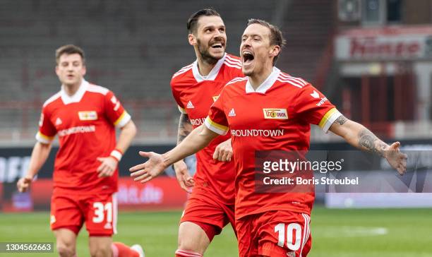 Max Kruse of 1.FC Union Berlin celebrates with teammates after scoring his team's first goal by penalty during the Bundesliga match between 1. FC...