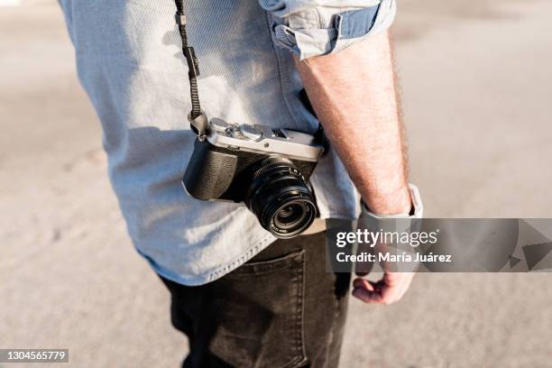 man holding a mirrorless digital camera - digital single lens reflex camera stock pictures, royalty-free photos & images