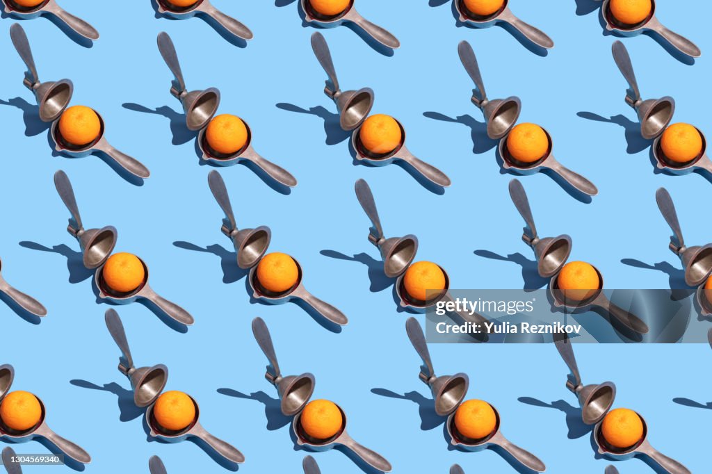 Repeated lemon squeezer and blood orange on the blue background