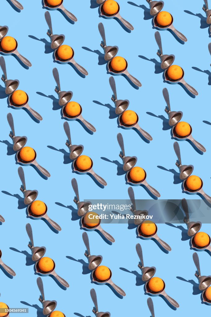 Repeated lemon squeezer and blood orange on the blue background