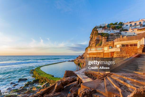 picturesque village azenhas do mar. landscape at sunset.  holiday white houses on the edge of a cliff with a beach and swimming pool below. landmark near lisbon, portugal, europe. - azenhas do mar imagens e fotografias de stock