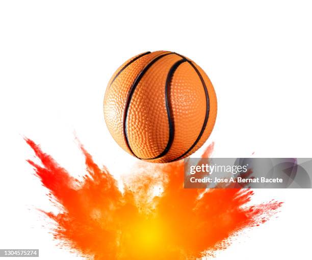 impact and rebound of a ball of basketball on a surface of land and powder on a white background - ballon rebond stock-fotos und bilder