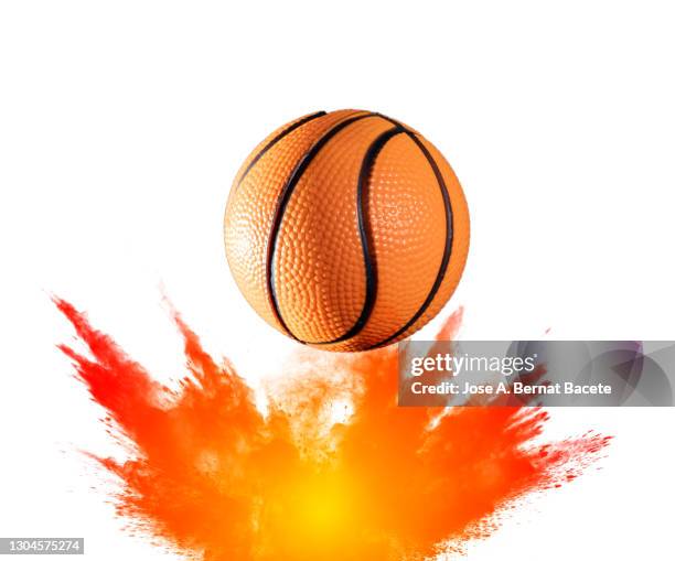 impact and rebound of a ball of basketball on a surface of land and powder on a white background - ballon rebond stock pictures, royalty-free photos & images