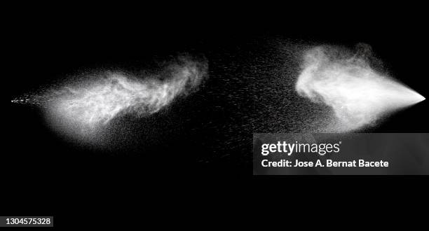 collision of two pressurized water jets on a black background. - spray paint isolated stock pictures, royalty-free photos & images