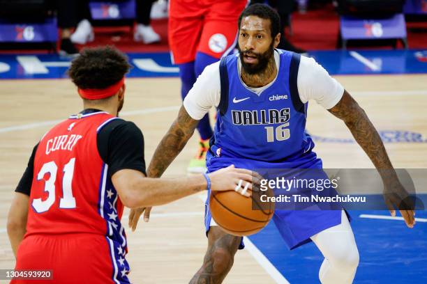 James Johnson of the Dallas Mavericks guards Seth Curry of the Philadelphia 76ers at Wells Fargo Center on February 25, 2021 in Philadelphia,...