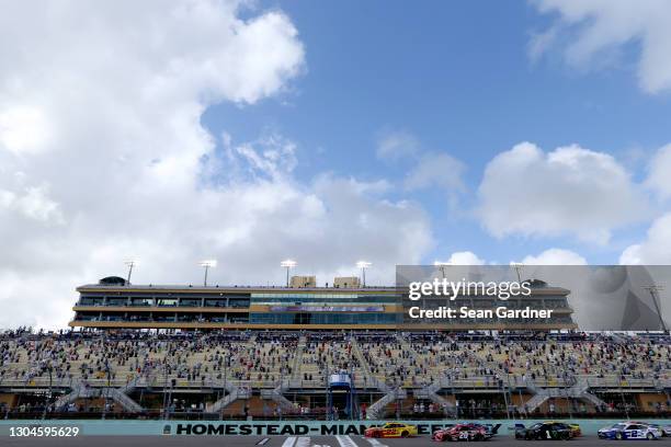 Joey Logano, driver of the Shell Pennzoil Ford, and Christopher Bell, driver of the Rheem Toyota, lead the field to start the NASCAR Cup Series Dixie...