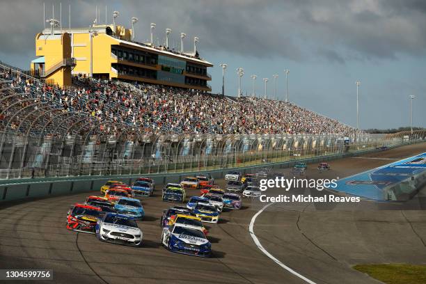 Brad Keselowski, driver of the Dent Wizard Ford, and Chris Buescher, driver of the Fastenal Ford, leads the field during the NASCAR Cup Series Dixie...