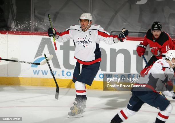 Alex Ovechkin of the Washington Capitals complains to the ref as his stick is broken by a slash during the third period against the New Jersey Devils...