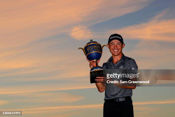 Collin Morikawa of the United States celebrates with the Gene Sarazen Cup during the trophy ceremony after winning the final round of World Golf...