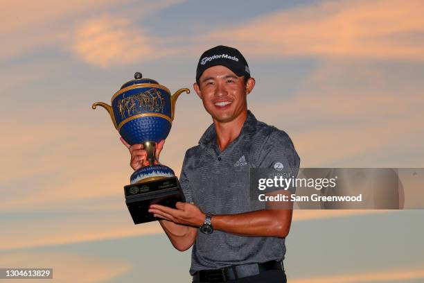 Collin Morikawa of the United States celebrates with the Gene Sarazen Cup during the trophy ceremony after winning the final round of World Golf...
