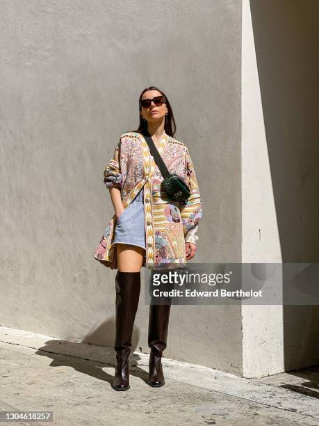 Julia Comil wears sunglasses from Chanel, a colored floral print wool cardigan from Etro, a green leather belt bag from Faure Le Page, French terry...
