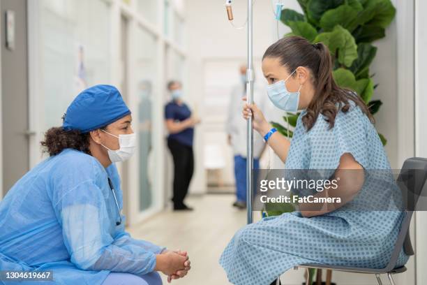 having a chat with my nurse stock photo - operating gown stock pictures, royalty-free photos & images