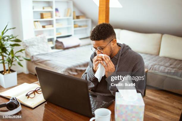 young african-american man has an allergic reaction - allergies indoors stock pictures, royalty-free photos & images