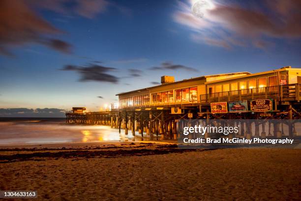 cocoa beach pier and the full moon - cocoa beach stock-fotos und bilder