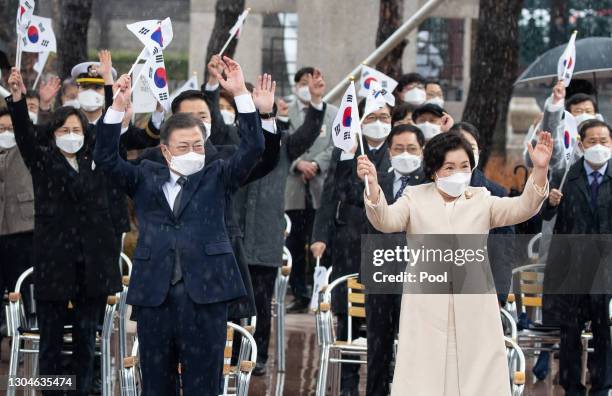 South Korean president Moon Jae-in and his wife Kim Jung-sook , give three cheers during a ceremony of the 102nd Independence Movement Day ceremony...