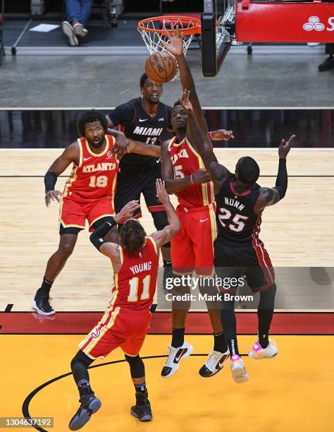 Clint Capela of the Atlanta Hawks blocks the shot against Kendrick Nunn of the Miami Heat during the third quarter at American Airlines Arena on...