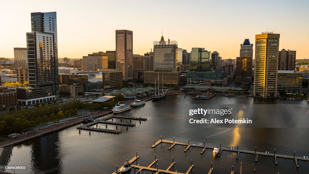 The aerial view of the Inner Harbor on Patapsco River in Baltimore, Maryland, USA, at sunset.