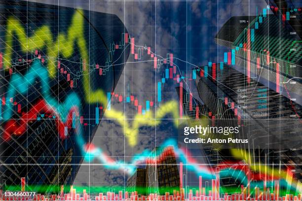 stock charts on the background of skyscrapers. financial system concept - collapsing stock-fotos und bilder