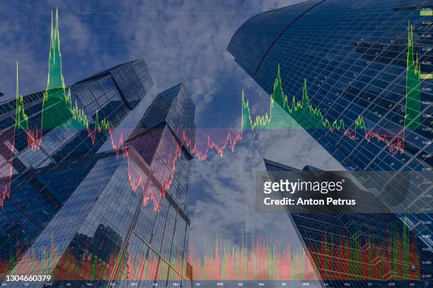 stock charts on the background of skyscrapers. financial system concept - collapsing stock-fotos und bilder